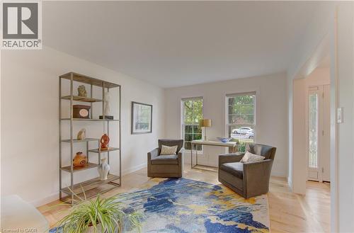 Light-filled interior featuring wood-finish flooring, white walls, and a wide entryway - 307 Grand River Boulevard, Kitchener, ON - Indoor
