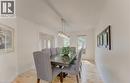 Dedicated dining area featuring wood-finish flooring, light-toned walls, and a linear pendant light fixture - 307 Grand River Boulevard, Kitchener, ON  - Indoor Photo Showing Dining Room 