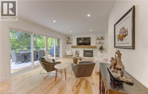 Living area featuring light wood-finish flooring and a fireplace with a wood mantel - 307 Grand River Boulevard, Kitchener, ON - Indoor With Fireplace