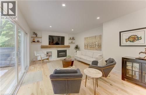 Bright living area featuring light wood-finish flooring, recessed lighting, and white walls - 307 Grand River Boulevard, Kitchener, ON - Indoor Photo Showing Living Room With Fireplace