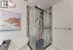 Freestanding soaking tub complemented by a glass-enclosed shower with a matte black fixture - 