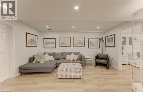 Spacious room featuring light wood-finish flooring, recessed lighting, and white baseboards - 307 Grand River Boulevard, Kitchener, ON - Indoor