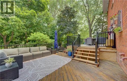 Multi-level wooden deck featuring black metal railings and brick exterior - 307 Grand River Boulevard, Kitchener, ON - Outdoor With Deck Patio Veranda With Exterior