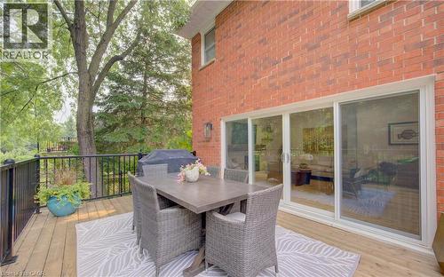 Expansive outdoor deck featuring wood flooring, black metal railings, and a brick exterior - 307 Grand River Boulevard, Kitchener, ON - Outdoor With Deck Patio Veranda With Exterior