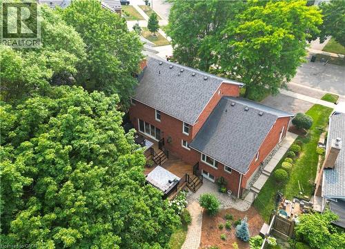 Brick exterior residence featuring a multi-level deck, dark shingle roofing, and established landscaping - 307 Grand River Boulevard, Kitchener, ON - Outdoor With Deck Patio Veranda