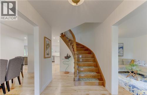 Hardwood staircase with decorative balusters and wood-finish flooring - 307 Grand River Boulevard, Kitchener, ON - Indoor Photo Showing Other Room