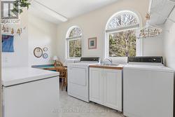 Main Floor Laundry Room w/ Storage and Workspace - 