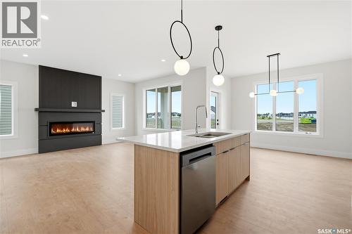218 Veterans Drive, Warman, SK - Indoor Photo Showing Kitchen With Fireplace