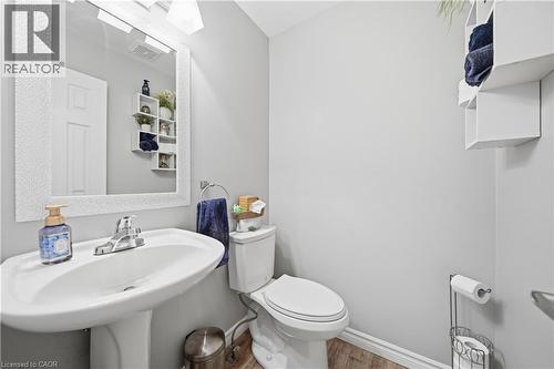Bathroom featuring a pedestal sink with chrome faucet, toilet, and decorative wall shelving - 79 Beaverbrook Crescent, Cambridge, ON - Indoor Photo Showing Bathroom