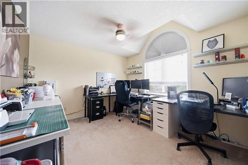 Spacious room featuring vaulted ceilings, a large arched window with horizontal blinds, neutral carpet flooring, and a ceiling fan with integrated lighting - 79 Beaverbrook Crescent, Cambridge, ON - Indoor Photo Showing Office