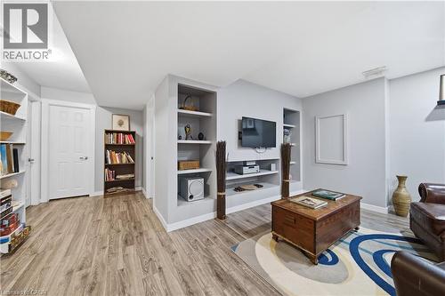Recreational area featuring wood-finish flooring, recessed lighting, and a built-in media center with shelving - 79 Beaverbrook Crescent, Cambridge, ON - Indoor