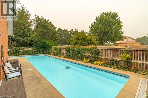 Rectangular in-ground swimming pool with a concrete surround - 79 Beaverbrook Crescent, Cambridge, ON - Outdoor With In Ground Pool With Deck Patio Veranda With Backyard