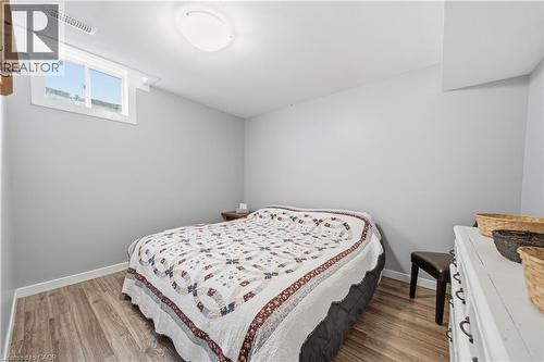 Room featuring wood-finish flooring, a white window frame, and a flush-mount ceiling light - 79 Beaverbrook Crescent, Cambridge, ON - Indoor Photo Showing Bedroom