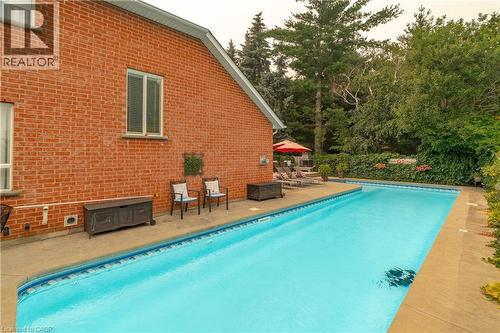 Rectangular inground swimming pool with a concrete surround - 79 Beaverbrook Crescent, Cambridge, ON - Outdoor With In Ground Pool With Deck Patio Veranda