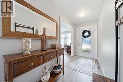 Entryway featuring light wood-finish flooring and neutral wall tones - 