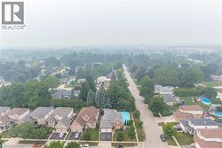 Aerial overview of a residential neighborhood with mature tree canopies - 