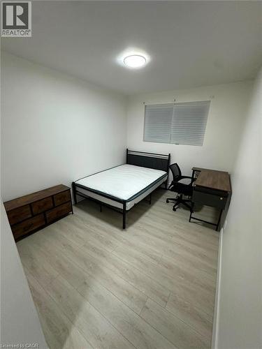 Room featuring light wood-finish flooring, white painted walls, and a ceiling-mounted light fixture - 145 Macgregor Crescent Unit# 2 (R1), Waterloo, ON - Indoor Photo Showing Other Room