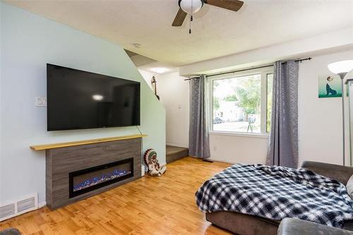 241 Lake Ridge Rd, Winnipeg, MB - Indoor Photo Showing Bedroom With Fireplace