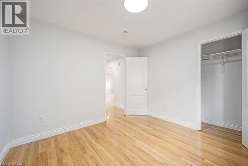 Hardwood flooring complemented by white baseboards and neutral wall tones - 5 Freshspring Drive, Brampton, ON - Indoor Photo Showing Other Room