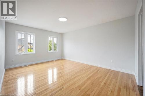 Spacious room featuring wood-finish flooring and two multi-pane windows - 5 Freshspring Drive, Brampton, ON - Indoor Photo Showing Other Room