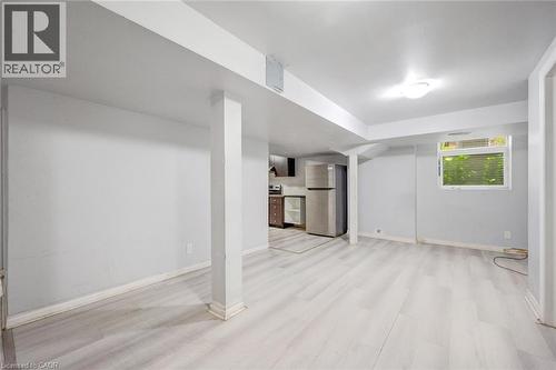 Spacious lower-level room featuring light wood-finish flooring, recessed lighting, and a kitchen area with stainless steel appliances - 5 Freshspring Drive, Brampton, ON - Indoor