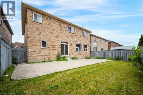 Expansive backyard featuring a large concrete patio, a grass lawn, and full privacy fencing - 5 Freshspring Drive, Brampton, ON - Outdoor