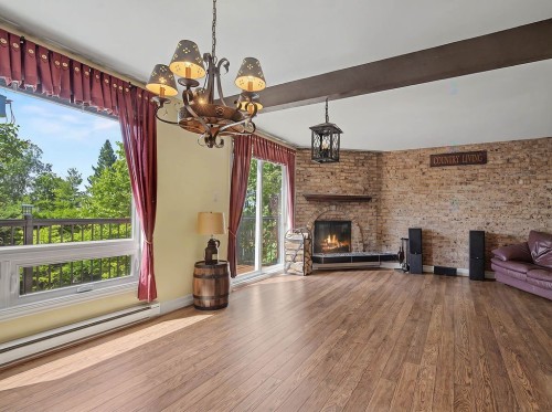Living Room - 767 Rue Richer, Sainte-Adèle, QC - Indoor With Fireplace