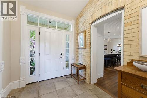 Entry foyer featuring a white paneled door with sidelights, a transom window, and intricate trim work - 8430 Road 146, Listowel, ON - Indoor Photo Showing Other Room