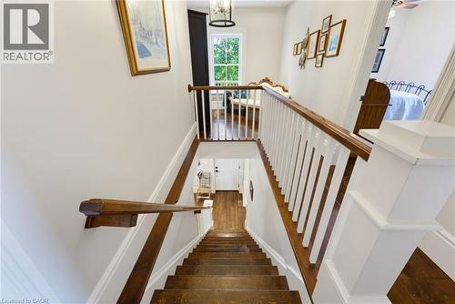 Hardwood staircase with white risers and stained wood treads - 8430 Road 146, Listowel, ON - Indoor Photo Showing Other Room