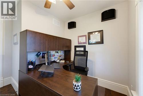 Dedicated workspace featuring a built-in wood-finish desk with an upper cabinet system - 8430 Road 146, Listowel, ON - Indoor Photo Showing Other Room