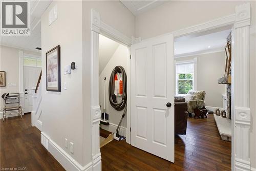 Hardwood-finish flooring throughout, featuring detailed white trim and baseboards - 8430 Road 146, Listowel, ON - Indoor Photo Showing Other Room