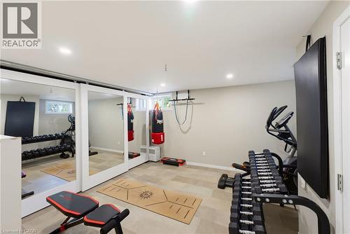 Dedicated fitness space featuring recessed lighting, light-toned wall paint, and durable tile flooring - 8430 Road 146, Listowel, ON - Indoor Photo Showing Gym Room