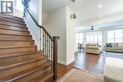 Hardwood staircase with wrought iron balusters and a dark wood handrail - 