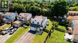 Two-story residence featuring a covered front porch, attached garage, and a paved driveway - 