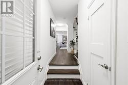 Entrance way with powder room to right - 