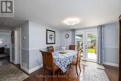 Dining Room with French Doors Leading to Backyard - 