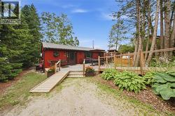 Red exterior residence with a metal roof and an expansive wood deck - 