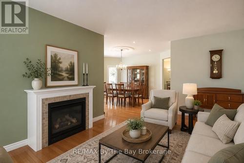 virtually staged - 60 Martyn Drive, Wasaga Beach, ON - Indoor Photo Showing Living Room With Fireplace