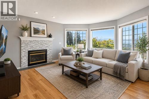 *This photo has been virtually staged* - 877 Toovey Road, Kelowna, BC - Indoor Photo Showing Living Room With Fireplace