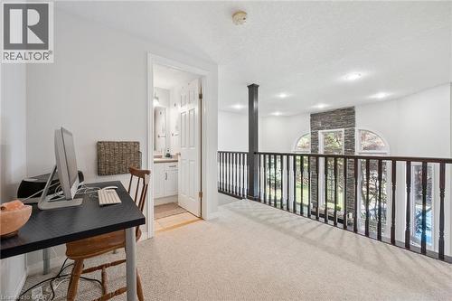 Loft area with carpet flooring, dark wood railing, and recessed lighting - 916 Rush Meadow Court, Kitchener, ON - Indoor Photo Showing Office