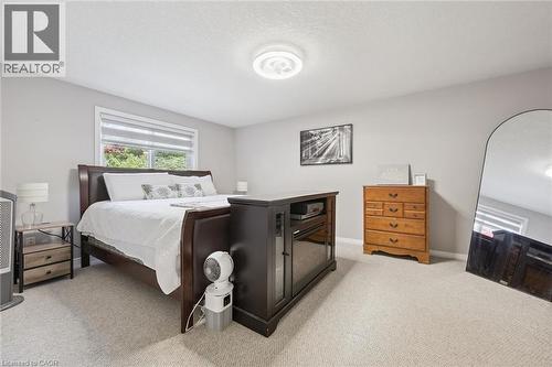 Soft gray wall paint and light-toned carpeting create a bright interior - 916 Rush Meadow Court, Kitchener, ON - Indoor Photo Showing Bedroom