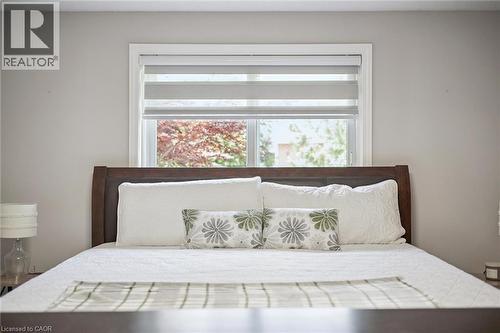 Neutral-toned bedroom featuring a window with layered roller shades - 916 Rush Meadow Court, Kitchener, ON - Indoor Photo Showing Bedroom