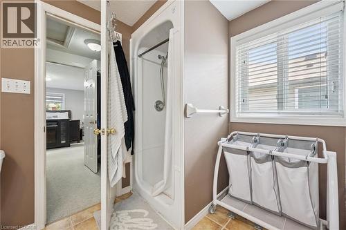 Three-piece bathroom featuring a stand-up shower with a clear enclosure, a single window with blinds, and tile flooring - 916 Rush Meadow Court, Kitchener, ON - Indoor
