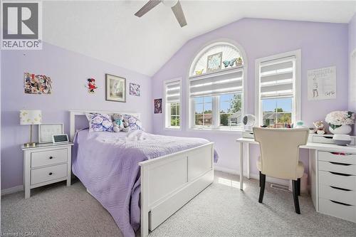 Vaulted ceiling bedroom featuring triple windows, including a prominent arched window, and neutral carpeting - 916 Rush Meadow Court, Kitchener, ON - Indoor Photo Showing Bedroom