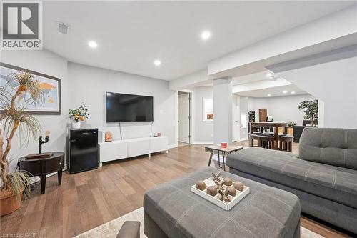 Open concept living space featuring wood-finish flooring, recessed lighting, and light grey walls - 916 Rush Meadow Court, Kitchener, ON - Indoor Photo Showing Living Room