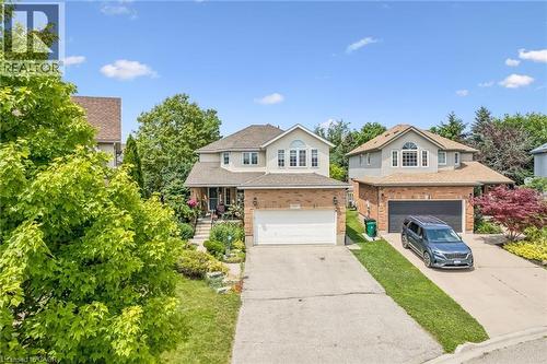 Traditional two-story residence featuring a combination of brick and stucco exterior, an attached garage, and a concrete driveway - 916 Rush Meadow Court, Kitchener, ON - Outdoor With Facade