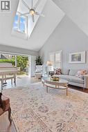 Vaulted ceilings with a prominent skylight and ceiling fan - 