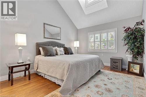 Room featuring vaulted ceilings, wood-finish flooring, and a skylight - 350 Doon Valley Drive Unit# 6D, Kitchener, ON - Indoor Photo Showing Bedroom
