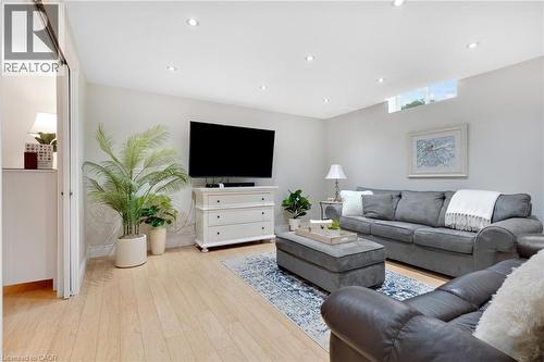 Spacious room featuring light wood-finish flooring, recessed lighting, and a transom window - 350 Doon Valley Drive Unit# 6D, Kitchener, ON - Indoor Photo Showing Living Room