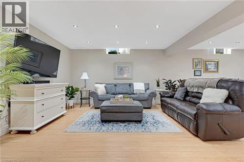 Spacious lower-level living area featuring light wood-finish flooring, recessed lighting, and neutral wall tones - 350 Doon Valley Drive Unit# 6D, Kitchener, ON - Indoor Photo Showing Living Room